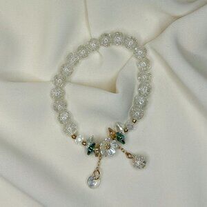 White beaded bracelet with a white flower charm!